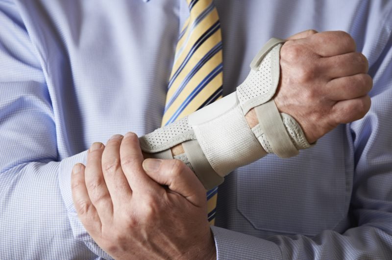 Close Up Of Businessman Suffering With Repetitive Strain Injury (RSI)